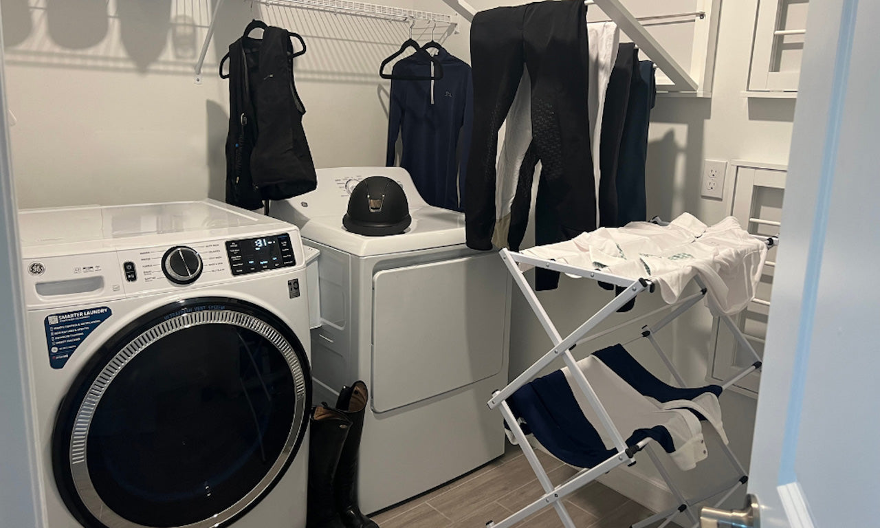 equestrian apparel getting washed and hanging to dry in laundry room