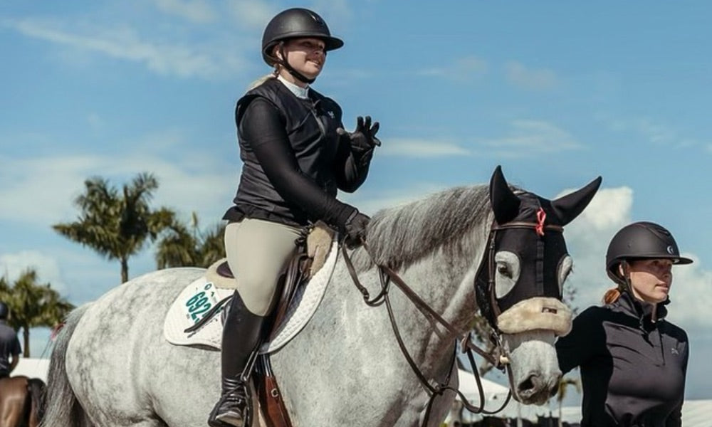 Professional horseback rider on a white horse